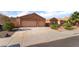 Charming single-story home with a three-car garage, desert landscaping, and neutral color palette at 940 Rifle Dr, Henderson, NV 89002