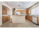 Bright kitchen featuring tile floors, wood cabinets, white appliances and a central island at 940 Rifle Dr, Henderson, NV 89002
