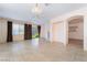 Open-concept living room with tile floors, fireplace, and access to the outdoors and kitchen at 940 Rifle Dr, Henderson, NV 89002