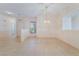 Spacious living room with tile flooring, natural light, and elegant chandelier at 940 Rifle Dr, Henderson, NV 89002