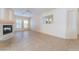 Bright living room featuring tile floors, fireplace, ceiling fan and plenty of natural light at 940 Rifle Dr, Henderson, NV 89002