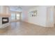 Bright living room featuring tile floors, fireplace, ceiling fan and plenty of natural light at 940 Rifle Dr, Henderson, NV 89002