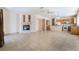 Open-concept living room boasts a fireplace, tile flooring, and seamless flow into the kitchen for easy entertaining at 940 Rifle Dr, Henderson, NV 89002