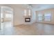 Bright living room with tile flooring, fireplace, and arched doorways to the adjacent rooms at 940 Rifle Dr, Henderson, NV 89002