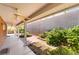 Covered patio featuring a ceiling fan overlooking the landscaped backyard with a privacy wall at 940 Rifle Dr, Henderson, NV 89002