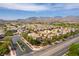 Expansive aerial view of a vibrant neighborhood with mountain views under a clear, blue sky at 10229 Mayflower Bay Ave, Las Vegas, NV 89166