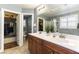 Bathroom featuring double sinks, walk-in shower, and adjacent walk-in closet at 10229 Mayflower Bay Ave, Las Vegas, NV 89166
