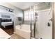 Bathroom showcasing a separate shower and tub, and wood-look floors at 10229 Mayflower Bay Ave, Las Vegas, NV 89166
