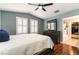 Bright bedroom with shutters, ceiling fan, dresser and walk in closet access at 10229 Mayflower Bay Ave, Las Vegas, NV 89166