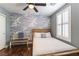 Serene bedroom with statement wall, ceiling fan, and natural light at 10229 Mayflower Bay Ave, Las Vegas, NV 89166