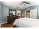 Spacious bedroom with a ceiling fan, dresser with mirror, and ensuite bathroom access at 10229 Mayflower Bay Ave, Las Vegas, NV 89166