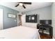 Bright bedroom featuring a ceiling fan, a desk and ensuite access at 10229 Mayflower Bay Ave, Las Vegas, NV 89166