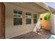 A charming covered patio featuring three windows, seating, and brick pavers at 10229 Mayflower Bay Ave, Las Vegas, NV 89166