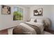 Bedroom with a large window and neutral decor at 10505 Jeremy Ridge Ave, Las Vegas, NV 89144