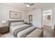 Staged bedroom with a ceiling fan, closet, and attached bathroom at 10505 Jeremy Ridge Ave, Las Vegas, NV 89144