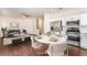 Inviting dining area with modern table setting and stainless steel appliances at 10505 Jeremy Ridge Ave, Las Vegas, NV 89144