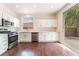 Modern kitchen with stainless steel appliances, white cabinets, and sliding glass door at 10505 Jeremy Ridge Ave, Las Vegas, NV 89144