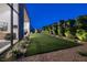 Landscaped backyard featuring well-manicured lawn, privacy hedging and modern design at 10781 Agate Cliffs Ave, Las Vegas, NV 89135