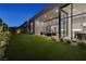 Expansive backyard with modern patio and seamless transition to the open-concept living spaces at 10781 Agate Cliffs Ave, Las Vegas, NV 89135