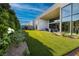 Lush backyard with manicured lawn, modern architecture and privacy landscaping at 10781 Agate Cliffs Ave, Las Vegas, NV 89135