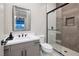 Modern bathroom featuring a glass enclosed shower with tasteful tile work and single sink vanity at 10781 Agate Cliffs Ave, Las Vegas, NV 89135