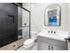 Modern bathroom featuring a glass enclosed shower with tasteful tile work and single sink vanity at 10781 Agate Cliffs Ave, Las Vegas, NV 89135