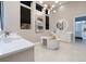 Elegant bathroom featuring modern lighting, a soaking tub and a sleek design at 10781 Agate Cliffs Ave, Las Vegas, NV 89135