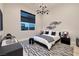 This bedroom offers neutral walls, modern decor, and a sleek ceiling light for an inviting space at 10781 Agate Cliffs Ave, Las Vegas, NV 89135