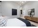 Modern bedroom with neutral walls, tasteful artwork, and a sleek ceiling light for an inviting space at 10781 Agate Cliffs Ave, Las Vegas, NV 89135