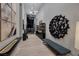 Modern hallway featuring elegant lighting fixtures and unique wall decor, leading to living spaces at 10781 Agate Cliffs Ave, Las Vegas, NV 89135