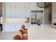 Close-up of a modern kitchen featuring quartz countertops, stainless steel appliances, and barstool seating at 10781 Agate Cliffs Ave, Las Vegas, NV 89135