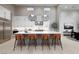 Bright, modern kitchen features a large island with seating and stainless steel appliances at 10781 Agate Cliffs Ave, Las Vegas, NV 89135