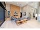 Bright, open living room with high ceilings, wood panel accent wall, and stylish modern furnishings at 10781 Agate Cliffs Ave, Las Vegas, NV 89135