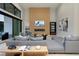 Comfortable living room features a decorative accent wall with fireplace and seamless indoor-outdoor living at 10781 Agate Cliffs Ave, Las Vegas, NV 89135