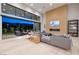 Spacious living room with floor-to-ceiling windows and access to outdoor living space at 10781 Agate Cliffs Ave, Las Vegas, NV 89135
