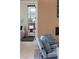 Cozy sitting area adjacent to a bedroom, with accent wall, comfortable seating, and neutral decor at 10781 Agate Cliffs Ave, Las Vegas, NV 89135