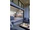 Inviting patio with a view into the open-concept kitchen and living area with modern decor at 10781 Agate Cliffs Ave, Las Vegas, NV 89135