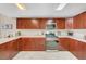 Updated kitchen with dark wooden cabinets and stainless steel appliances with tile flooring at 150 Las Vegas Blvd # 1503, Las Vegas, NV 89101