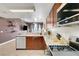 Modern kitchen featuring wooden cabinetry, stainless steel appliances, and stone countertops overlooking the living area at 150 Las Vegas Blvd # 1503, Las Vegas, NV 89101