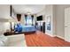 Comfortable primary bedroom featuring hardwood floors, a TV, and ample closet space at 150 Las Vegas Blvd # 1503, Las Vegas, NV 89101