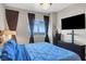 Serene bedroom showcasing a large window with city views and a dark wood dresser at 150 Las Vegas Blvd # 1503, Las Vegas, NV 89101