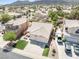 Overview of a suburban home with a two-car garage, surrounded by a well-kept lawn and mature landscaping at 1515 Horizon Crest Ct, Henderson, NV 89012