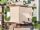 Home with red tile roof featuring a large patio area, well-manicured lawns, and green landscaping in the backyard at 1515 Horizon Crest Ct, Henderson, NV 89012