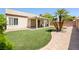 Lush backyard featuring manicured artificial turf and a covered patio at 1515 Horizon Crest Ct, Henderson, NV 89012