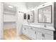 Bathroom featuring double sinks, white cabinets, and walk in closet at 1515 Horizon Crest Ct, Henderson, NV 89012