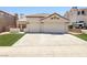 Charming single-story home with a well-manicured lawn and two-car garage at 1515 Horizon Crest Ct, Henderson, NV 89012