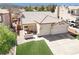 Inviting home featuring a manicured lawn, tiled roof, and a spacious driveway leading to a two-car garage at 1515 Horizon Crest Ct, Henderson, NV 89012