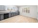 Bright kitchen with gray cabinets, stainless steel appliances, and wood flooring at 1515 Horizon Crest Ct, Henderson, NV 89012