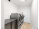 Bright laundry room with modern appliances, stylish cabinet and flooring at 1515 Horizon Crest Ct, Henderson, NV 89012