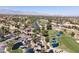 Aerial view of a community with lush landscaping, a golf course, and mountain views at 1813 Skyline Dr, Las Vegas, NV 89117